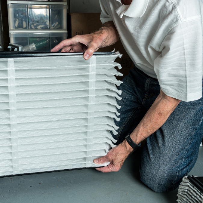 a man installing a clean Air conditioner Fliter